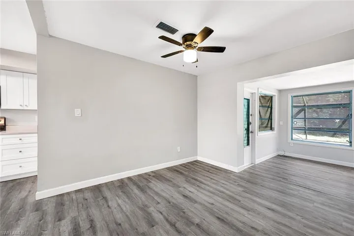 Unfurnished room featuring ceiling fan and hardwood / wood-style flooring