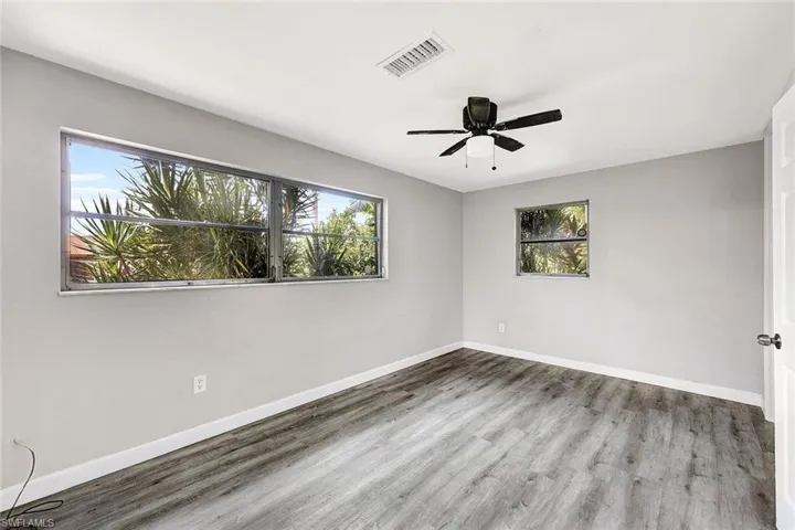 Empty room featuring ceiling fan and wood-type flooring