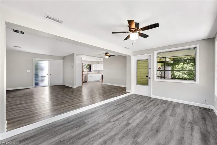Unfurnished living room with hardwood / wood-style floors and ceiling fan
