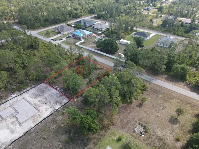 Aerial view of property and surrounding area featuring property boundaries highlighted