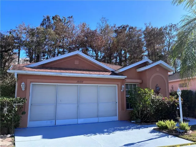 Ranch-style home with stucco siding, driveway, and an attached garage