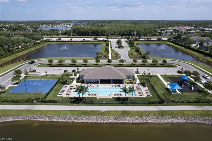 Birds eye view of property with a water view