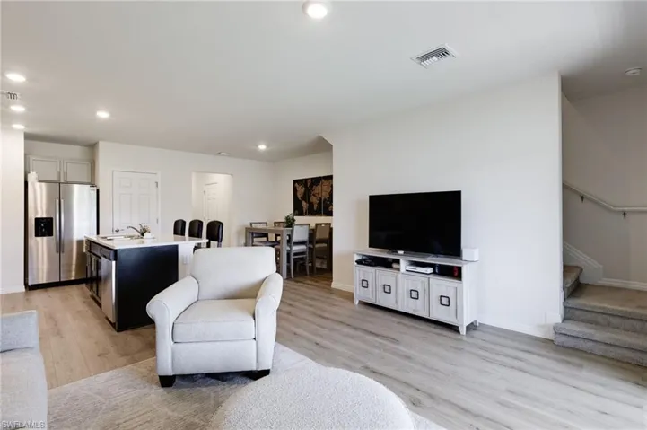 Living room featuring sink and light wood-type flooring