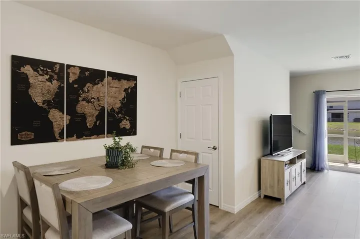 Dining area with light hardwood / wood-style flooring