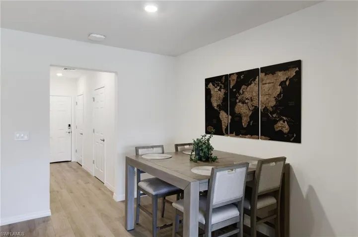 Dining space with light hardwood / wood-style flooring