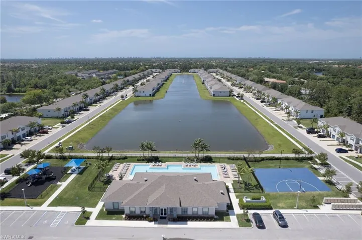 Birds eye view of property with a water view
