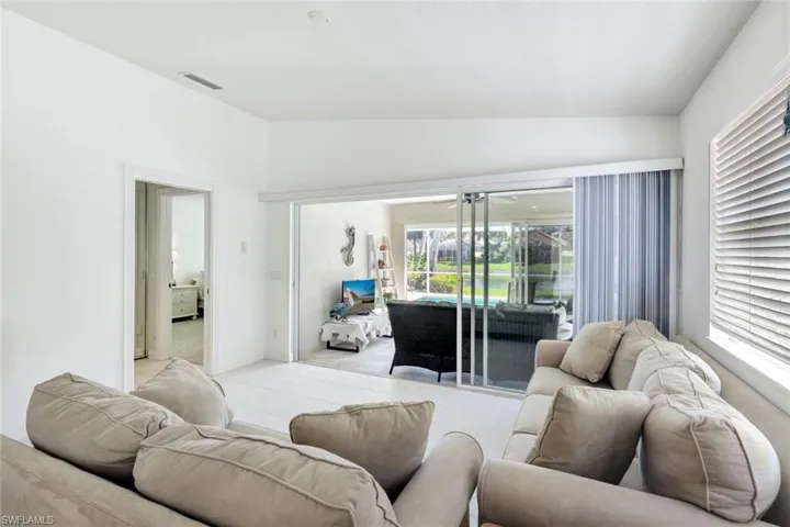 Living area featuring visible vents and vaulted ceiling