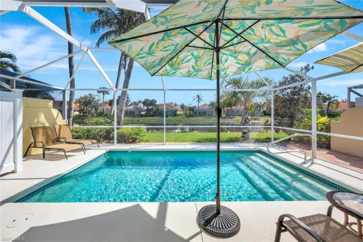 Pool featuring a patio area, a lanai, and a water view