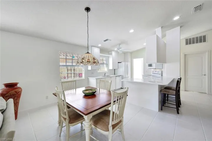 Dining space featuring light tile patterned floors, visible vents, and recessed lighting