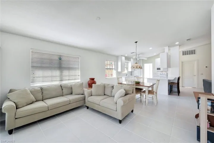 Living room featuring recessed lighting, visible vents, and light tile patterned flooring