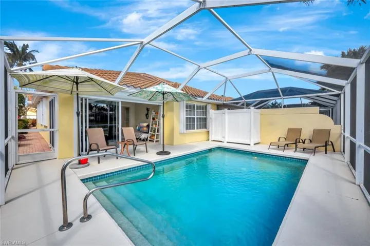 Outdoor pool with a patio area and a lanai