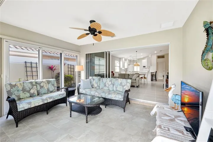 Living area featuring visible vents, ceiling fan, and light tile patterned flooring