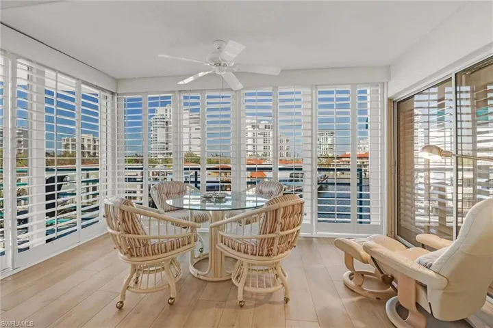 Sunroom with hardwood / wood-style flooring, a city view, and healthy amount of natural light