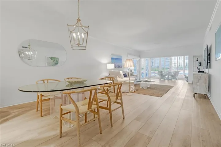 Dining area with light wood-type flooring and a chandelier