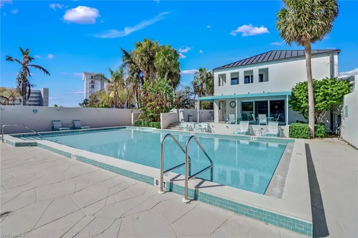 Community pool with a patio