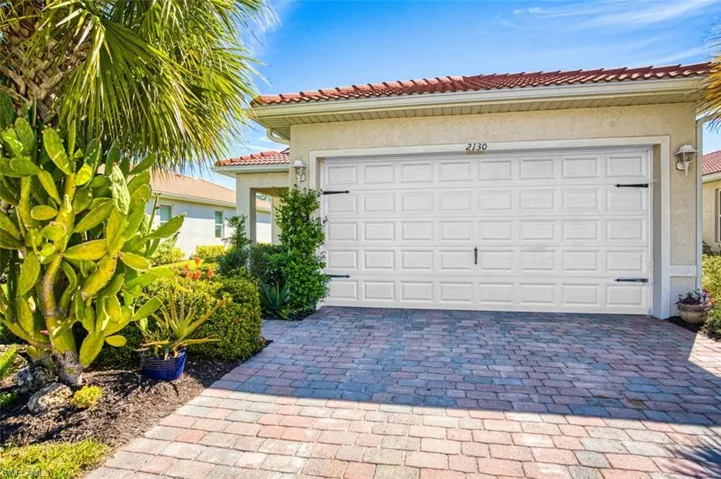 Garage featuring decorative driveway