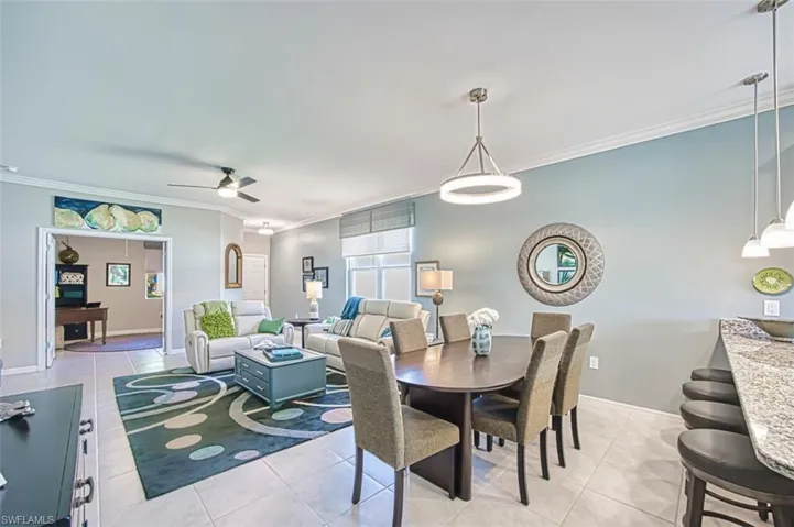 Dining room with updated modern lighting, and ceiling fans