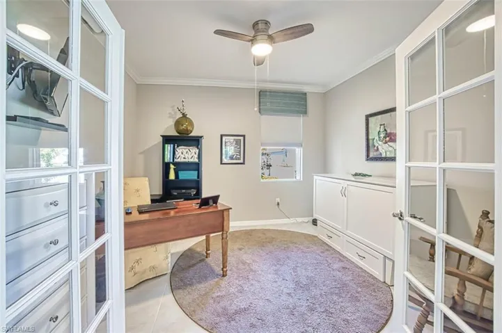 Office space with French doors with shades to accomodate guests, crown molding, tiled flooring, updated ceiling fan
