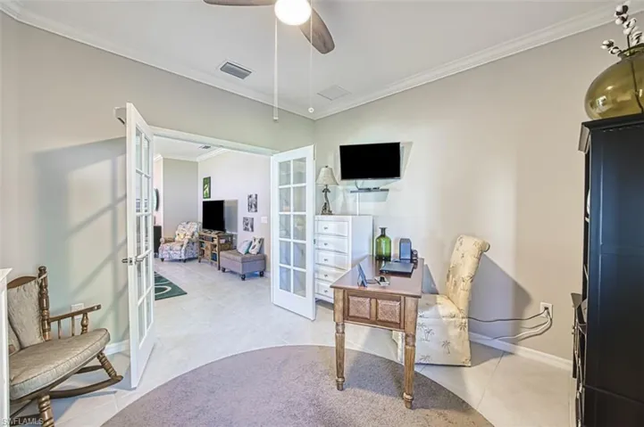 Home office featuring french doors with shades and crown molding