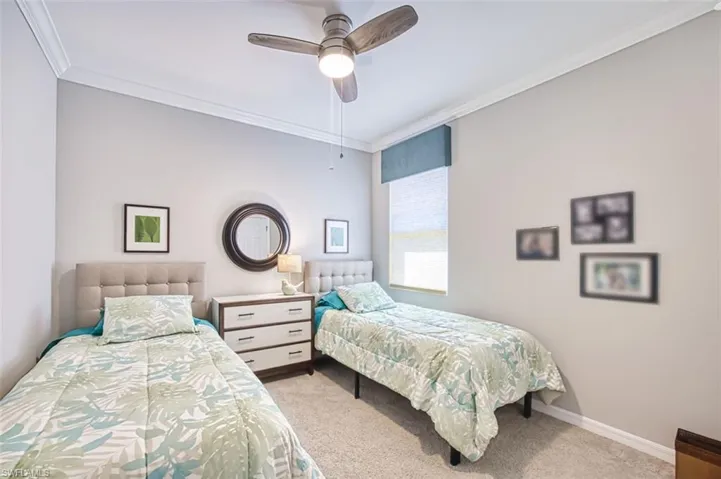 Bedroom featuring crown molding, baseboards, and carpet floors