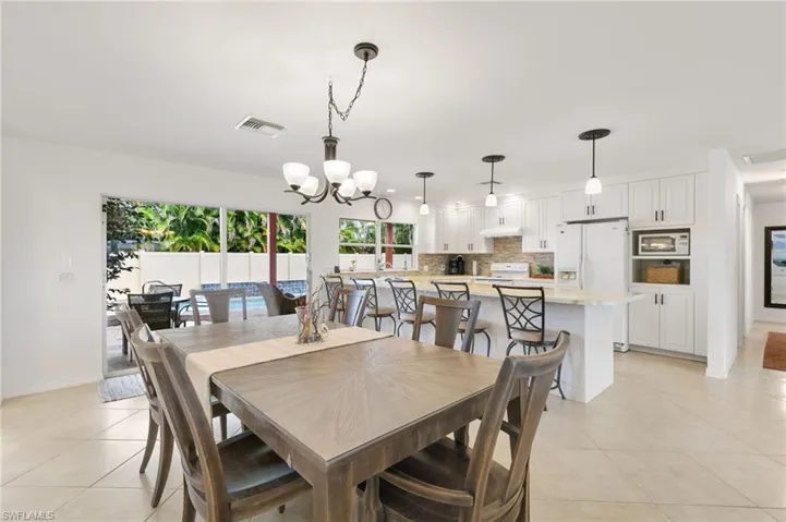 Dining room featuring a chandelier and light tile patterned floors