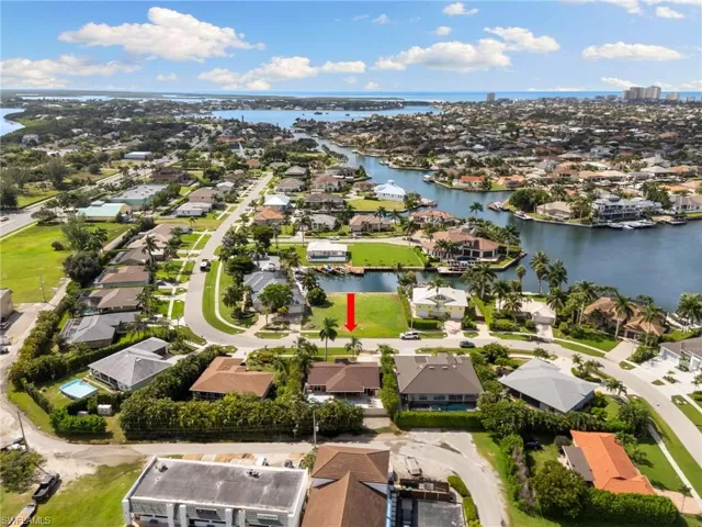 Aerial view of residential area featuring a large body of water
