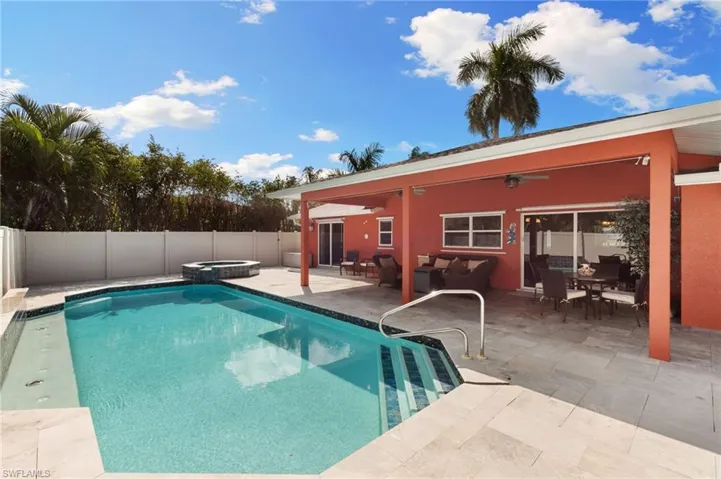View of pool with a patio area, a fenced backyard, outdoor lounge area, a pool with connected hot tub, and a ceiling fan