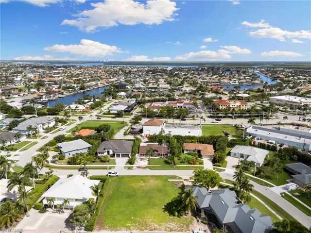 Aerial view of property's location featuring a large body of water and nearby suburban area
