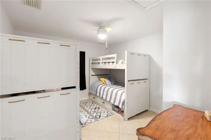 Bedroom featuring light tile patterned floors and a ceiling fan