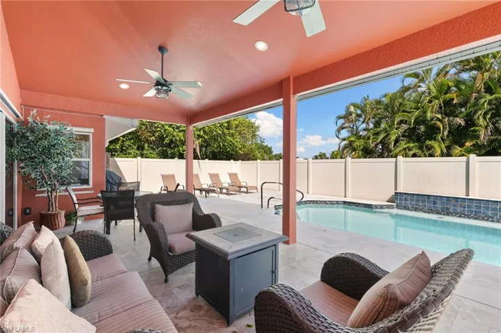 View of swimming pool featuring a patio area, ceiling fan, an outdoor living space, and a fenced backyard