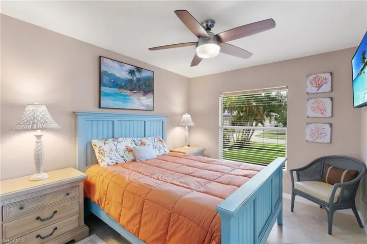 Bedroom with light tile patterned flooring and ceiling fan