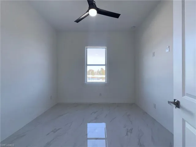 Spare room with ceiling fan