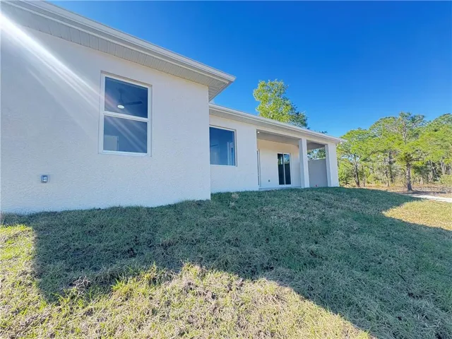 Back of property with a yard