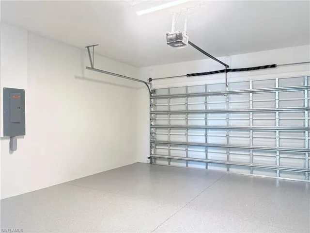 Garage with electric panel and a garage door opener