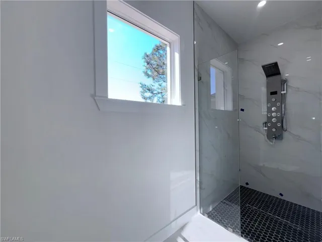 Bathroom featuring a tile shower