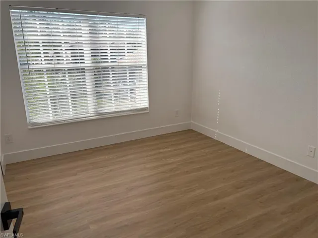 Unfurnished room with wood finished floors
