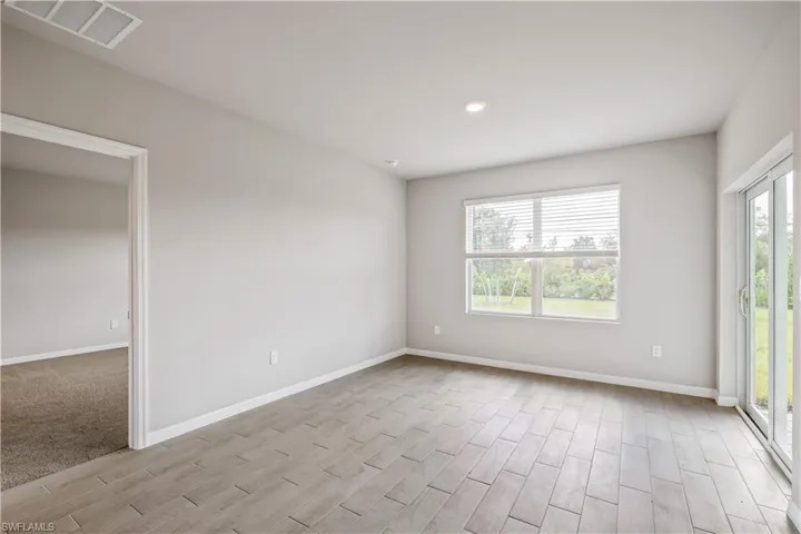 Spare room featuring light hardwood / wood-style flooring and a wealth of natural light