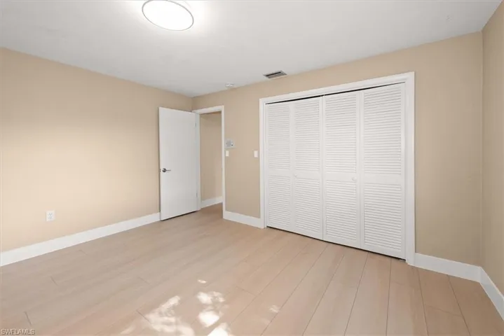 Neutral-toned walls complement wood-finish flooring in this room