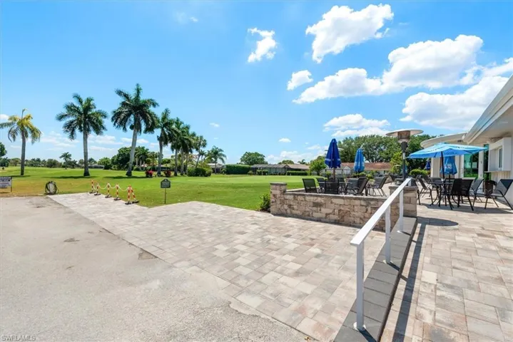 Expansive paver patio with stone veneer wall