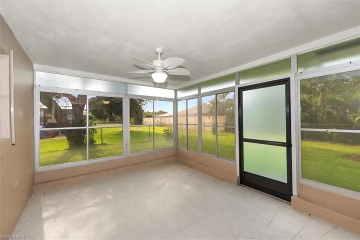 Enclosed patio featuring abundant natural light, ceramic tile flooring, a ceiling fan, and direct outdoor access