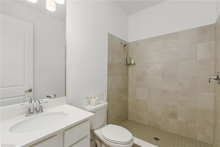 Full bathroom featuring vanity and a shower stall