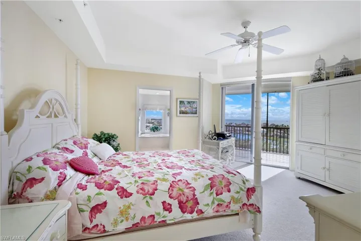 Bedroom featuring ceiling fan, access to exterior, and light carpet