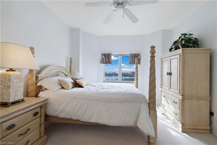Carpeted bedroom with ceiling fan