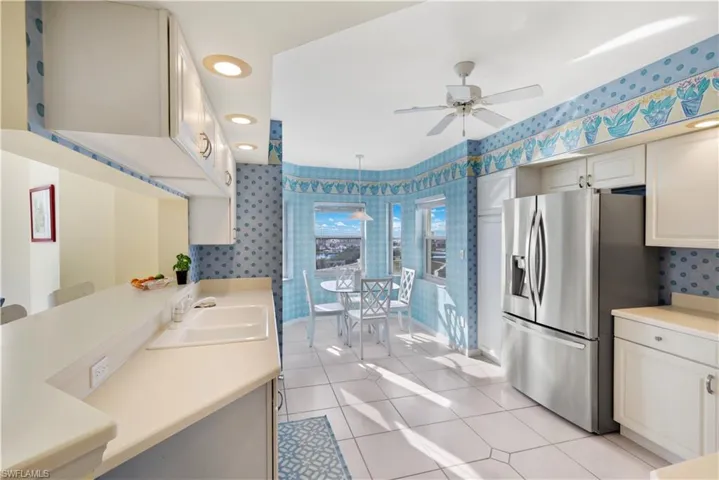 Bathroom featuring tile patterned floors, ceiling fan, sink, and a shower