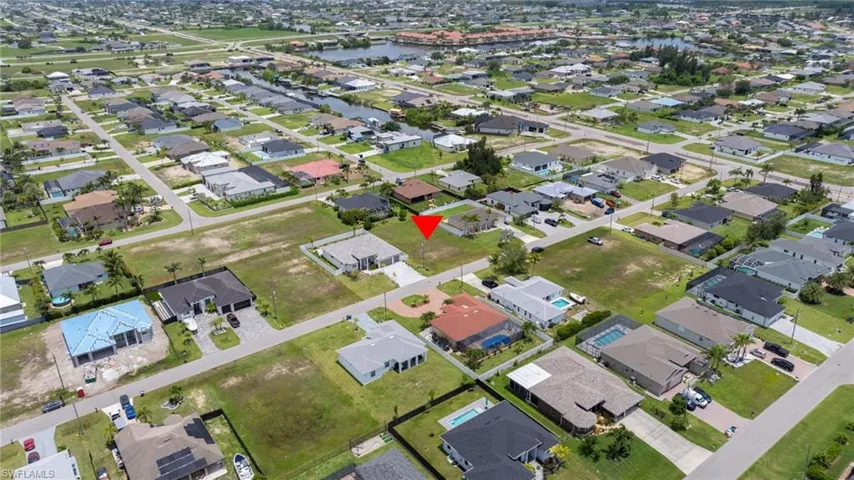 Aerial view of property's location with nearby suburban area