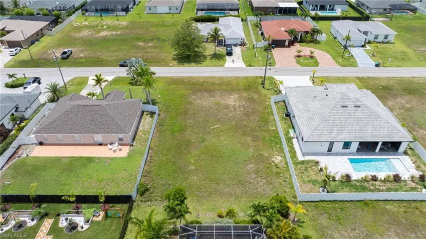 Aerial perspective of suburban area featuring a pool area
