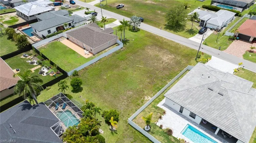 Aerial perspective of suburban area featuring a pool area