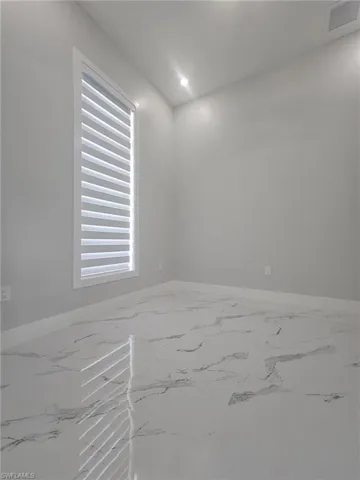 Spare room featuring recessed lighting, visible vents, marble finish floor, and baseboards