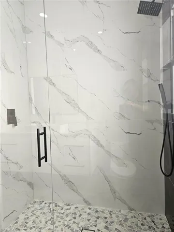 Full bathroom with recessed lighting and a marble finish shower
