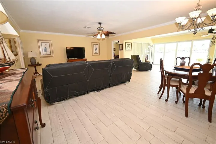 Open-concept living area with light-toned wood-finish flooring